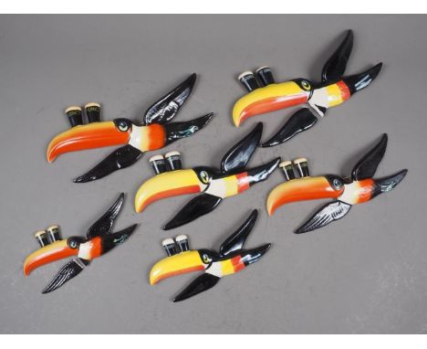 A set of three Carltonware Guinness flying toucan wall plaques, and another set (two toucans with broken wings)