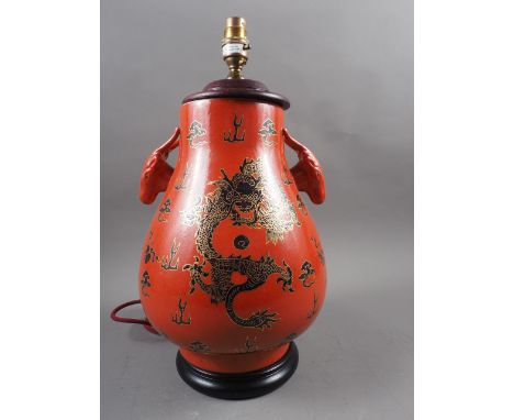 A Chinese table lamp with ram's head handles and dragon, cloud and flaming pearl decoration on an orange ground, 16 1/2" high