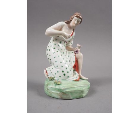 An 18th century Staffordshire polychrome enamel decorated figure of "Flora" picking flowers, on rock base, 4 3/4" high 