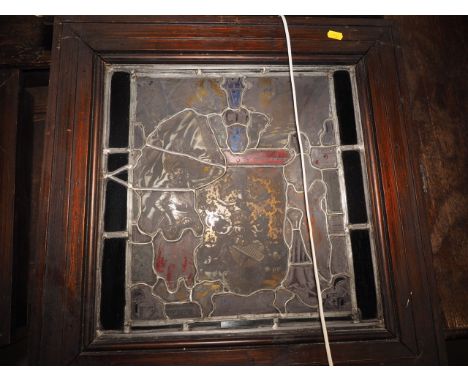An early 20th century back lit stained glass Flight into Egypt  and a leaded window, !6th coat of arms with figures in staine