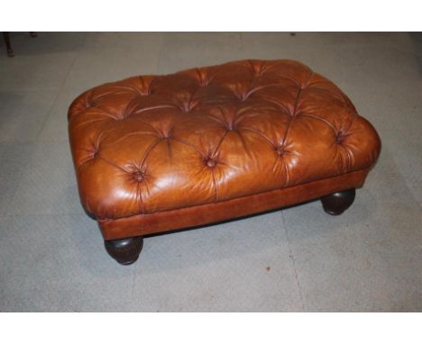 A Tetrad button upholstered leather topped stool, on turned supports, 38" wide x 28" deep x 16" highCondition:There's slight 