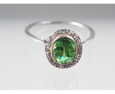 A white metal ring, set demantoid garnet, 2ct approx, and rose diamond collarCondition:There's a split on the shoulder of the