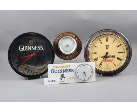 A Draught Guinness bar top clock, two Guinness wall clocks, an oak cased barometer and various other related items 