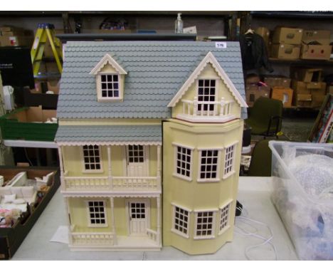 Large three story dolls house with light fittings . Height 72 cm length 62cm depth 42cm 