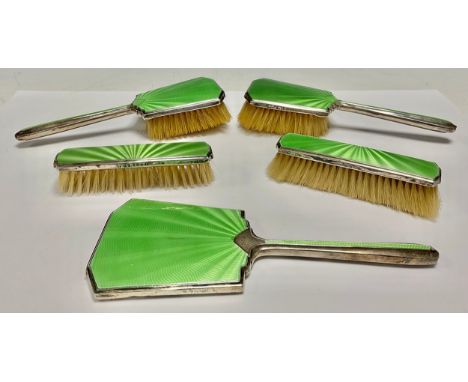 A George V silver and enamel five-piece hand mirror and brush set, lime green, engine turned enamel, hallmarked Birmingham 19