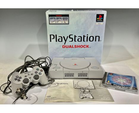 Retro Gaming - a PlayStation One Dualshock games console, one controller, one game Who Wants to be a Millionaire, original wr