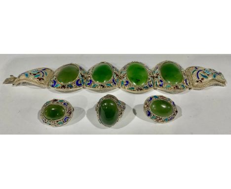 A suite of Chinese silver filigree and champlevé enamel jewellery, applied with polished jade cabochons, comprising bracelet,