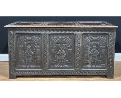 A 17th century style oak blanket chest, hinged top, three panel front, each carved with a Jacobean style full-length portrait