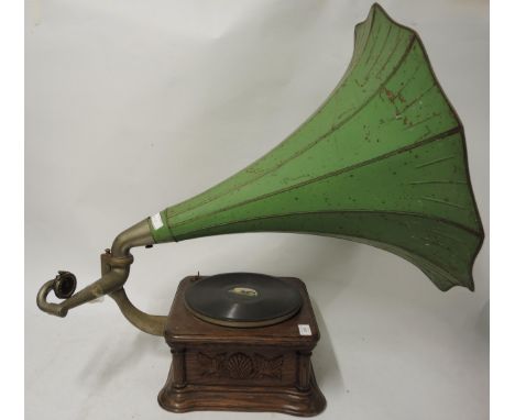 Oak cased table model wind-up gramophone with large toleware horn, with decorative carved oak case inscribed ' The Gramophone
