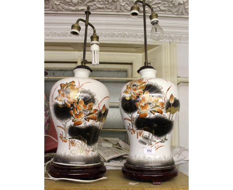 Pair of 20th Century Chinese baluster form pottery table lamps on circular wooden bases, decorated with lily pads, height inc