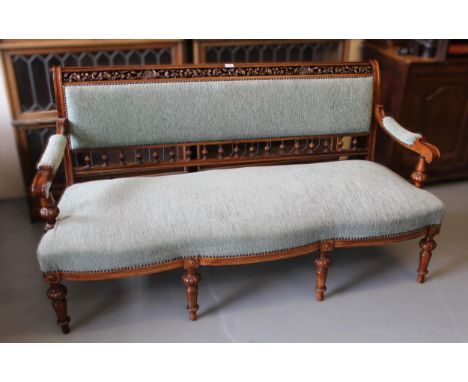 Victorian walnut upholstered sofa, the top rail pierced and leaf carved, the shaped seat on tapered legs, 160cm long 