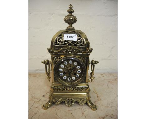 Late 19th French gilt brass mantel clock, the pierced dome shaped case with a baluster finial surmount and ornate side handle