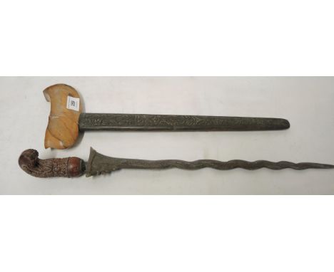 Javanese kris with a carved grip and a brass scabbard 