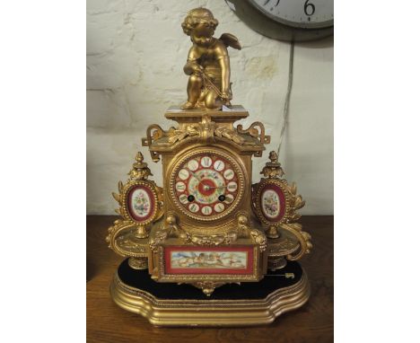 19th Century gilded spelter and porcelain mounted two train mantel clock with cherub surmount, 35cm high 