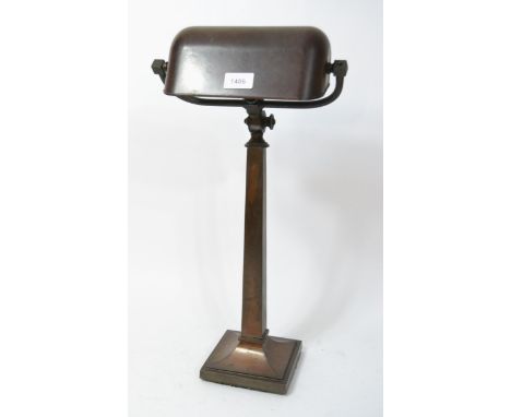 Early 20th Century dark patinated metal bankers lamp with Bakelite shade, 57cm high approximatelyLamp and shade in good condi