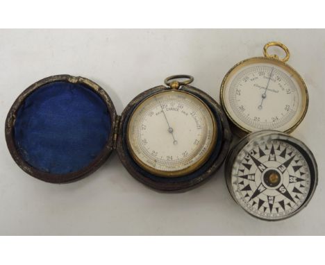 19th Century gilt metal pocket barometer housed in a leather case, together with another gilt pocket barometer and a compass 