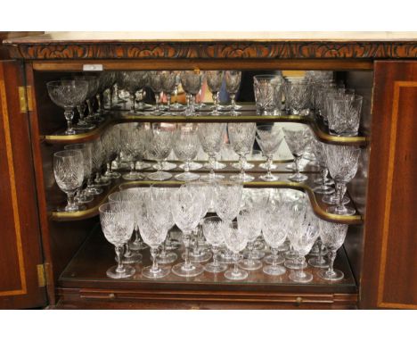 Suite of good quality cut glass drinking glasses by Thomas Webb housed in a reproduction mahogany drinks cabinet with three d
