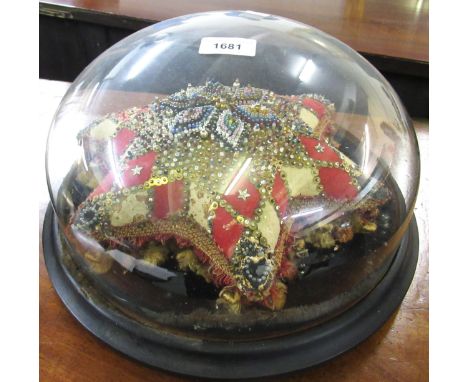 Victorian low circular glass dome housing a decorative star form cushion (at fault), another larger glass dome housing flower