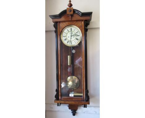 Late 19th Century Continental walnut and part ebonised Vienna style wall clock, the architectural case enclosing an enamel di