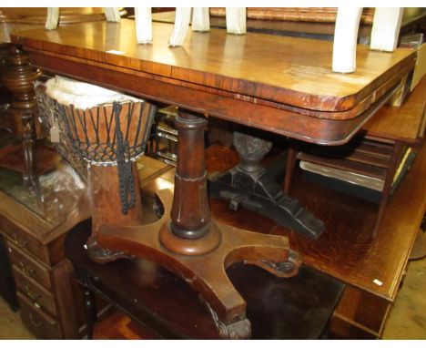19th Century rosewood rectangular fold-over card table, on turned column and quadruped base with scroll feet (for restoration