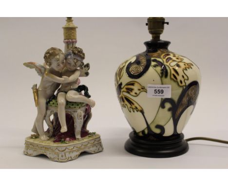 Modern Moorcroft table lamp, together with another Continental porcelain lamp in the form of two cherubs 