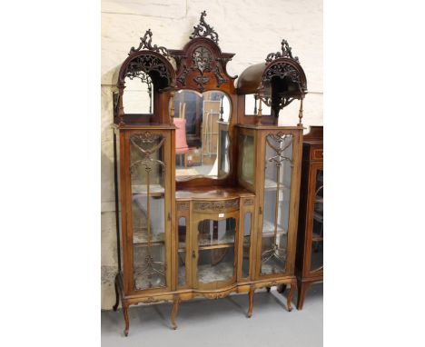 Large late 19th / early 20th Century mahogany display cabinet of ornate architectural form, the pierced, carved and mirror ba