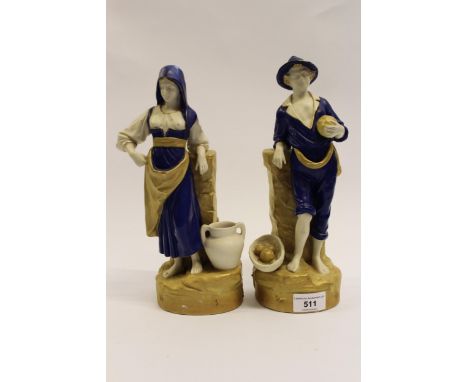 Pair of Royal Dux figures of a Continental peasant boy and girl in blue and gold shot enamel, the boy 28.6cm tall, the girl 2