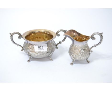 Early 20th Century silver cream jug and sugar basin with floral embossed decoration, Birmingham 1913, 14.5oz t 
