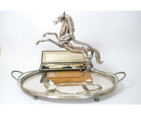 Oval silver plated galleried tray, large silver plated figure of a horse, cased pair of plated fish servers and a ladle 