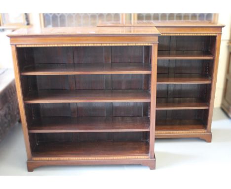 Pair of Edwardian mahogany satinwood crossbanded and line inlaid four shelf open bookcases, the moulded tops above inlaid fri