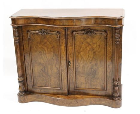 Victorian figured walnut chiffonier, the serpentine shaped top above a pair of carved and panel doors flanked by turned and c