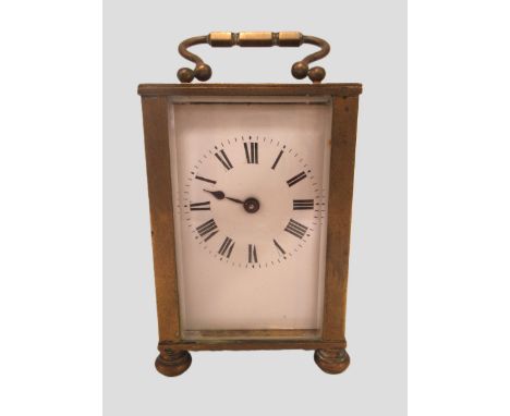Small brass cased carriage clock with enamel dial, Roman numerals and single train movement, 10cm high excluding the loop han