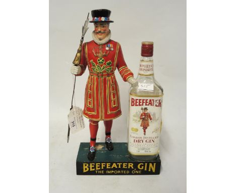Advertising figure for Beefeater gin, ' The import one ', with original empty bottle (at fault)Moulding around the middle of 