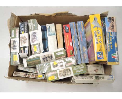 Box containing eighteen unmade plastic military model kits 