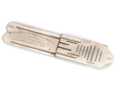 A nickel-plated brass Berrian Mfg Gold and Silver Counterfeit Coin Detector Rocker,American, with sixteen coin slots