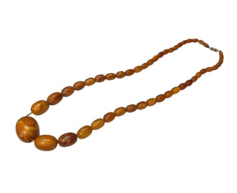 Vintage amber bead necklace with a string of oval polished graduated beads, largest bead measuring approximately 28mm x 20mm 