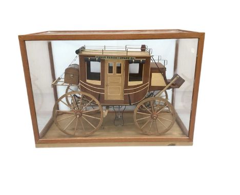Wooden model of a Wells Fargo stagecoach, in wooden display case measuring 46cm wide