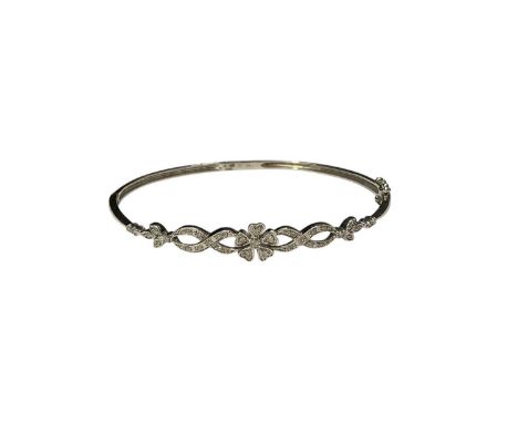 9ct white gold diamond set floral design hinged bangle, 16.5cm inner diameterLondon hallmarks. Weight 5.4 grams