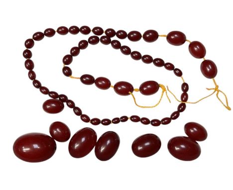 Vintage simulated cherry amber graduated bead necklace, needs re-stringing. Largest bead measures approximately 40mm x 25mm -