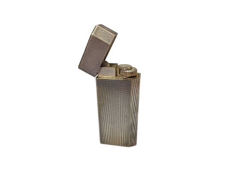 Cartier 'Must de Cartier' white metal lighter with engine turned decoration, numbered 82916S.Overall good condition. A few sc