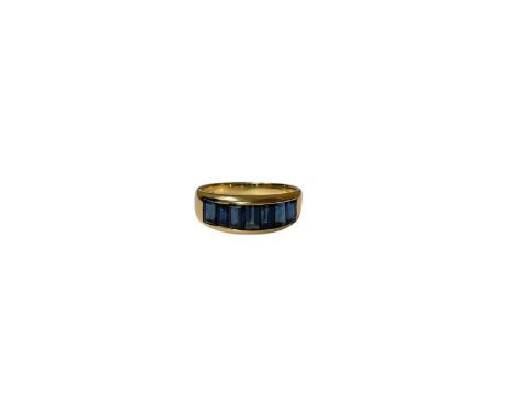 18ct gold blue sapphire seven stone ring with a row of seven rectangular step cut sapphires in 18ct gold channel setting (Lon