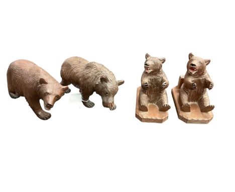 Four early to mid-20th century German Black Forest carved wooden bear ornaments pair bear pipe rests/ match box holders (4)