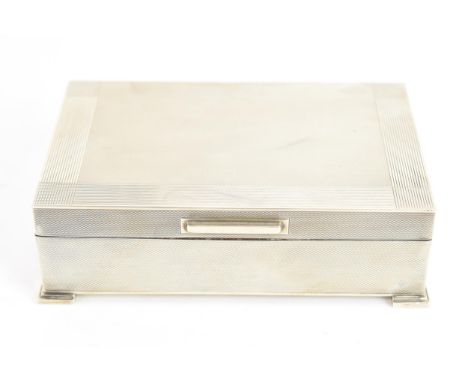 An Elizabeth II silver cigarette box, by Padgett & Braham Ltd, hallmarked London 1960, having an engine turned exterior stand