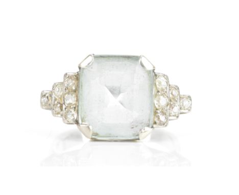 An Art Deco aquamarine and diamond dress ring, the central aquamarine 11.6mm x 9.9mm , flanked by twelve old cut diamonds to 