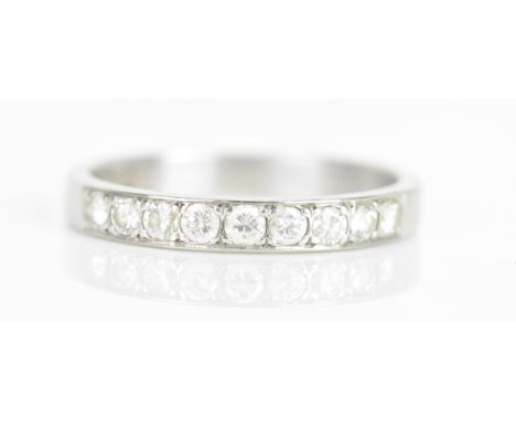 A diamond 18ct white gold half eternity ring, having nine brilliant cut diamonds, each measuring approximately 1.8mm, stamped