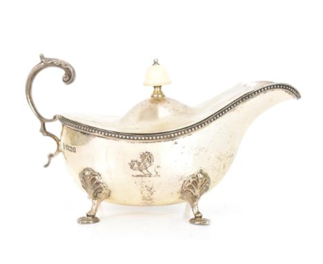 An Edwardian silver sauce boat with lid, by William Hutton & Sons Ltd, hallmarked Sheffield 1907, the lid having an ivory aco