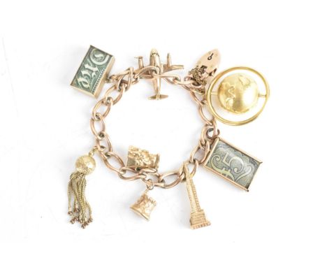 A 9ct yellow gold chain link charm bracelet, with a heart shaped padlock clasp, six 9ct gold charms, one 18ct gold globe char