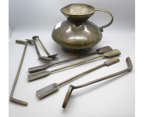 A bronze jug and seven moulded tools 