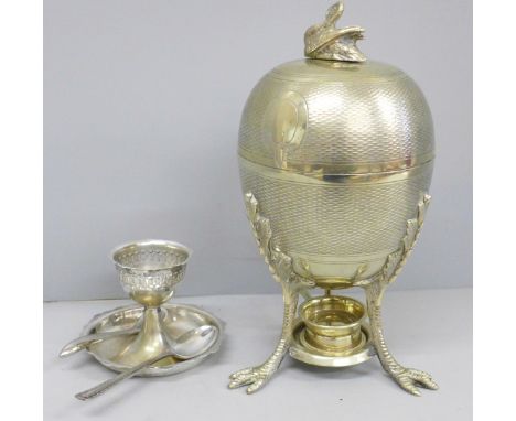 A plated egg warmer by Mappin and Webb, a pair of silver salt spoons, an egg cup and two other spoons