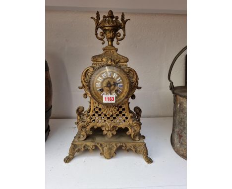 A cast and pierced brass mantel clock, 40cm high, (lacking pendulum).&nbsp; 